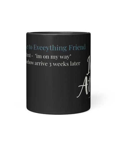 Black mug featuring humorous text about a late friend, highlighting their tendency to arrive weeks later.