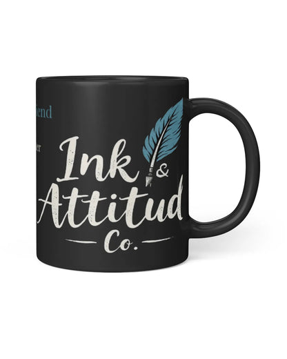 Black mug featuring the phrase "That late friend" with a blue feather and the brand name Ink & Attitude Co.