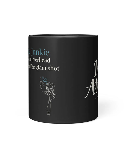Black coffee mug featuring the text "Selfie Junkie" and a playful illustration of a person taking a selfie.