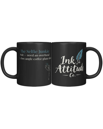 Black coffee mug featuring the text "The Selfie Junkie" and "Ink & Attitude Co." with a playful design.