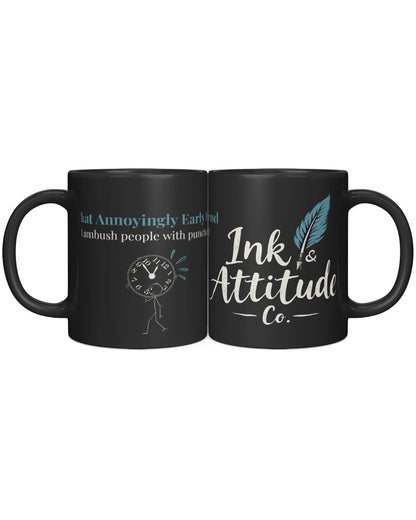 Black coffee mug featuring the phrase "That Annoyingly Early" with a cartoon clock and the brand name "Ink & Attitude Co."